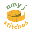 A logo featuring a tailor's tape measure in the centre with the wording 'amy j stitches' around it. amy j is in sage green, and stitches in a medium toned orange.